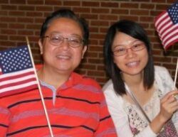 Two new citizens wave United States flags