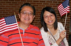 Two new citizens wave United States flags