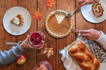 People sharing food on a Thanksgiving table