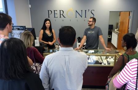Brazilian immigrants Brunna and Mike Peroni of Peroni’s Jewelry in Malden share their stories with teachers as part of an immigrant business story tour during the workshop.