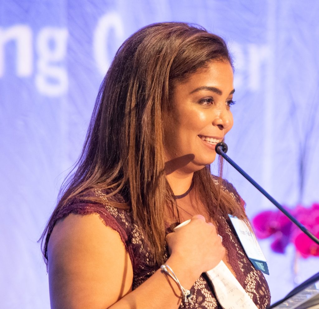 Yessy Feliz receiving her Immigrant Entrepreneur Award