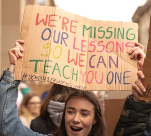 Young woman holding a protest sign