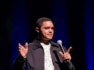 Trevor Noah performing stand-up on stage
