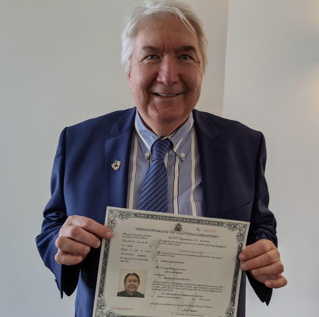 Ayhan holding his certificate of citizenship