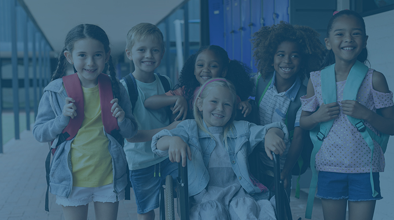 A diverse group of elementary school-age children smiling for the camera.