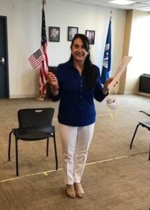 Mariagrazia holding an American flag after becoming a citizen