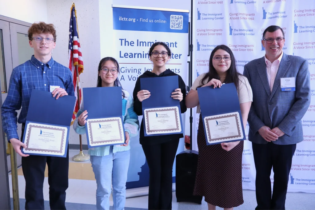 Four high school students standing side by side with Teen Perspectives certificates. The I.L.C. executive director is on the far right.